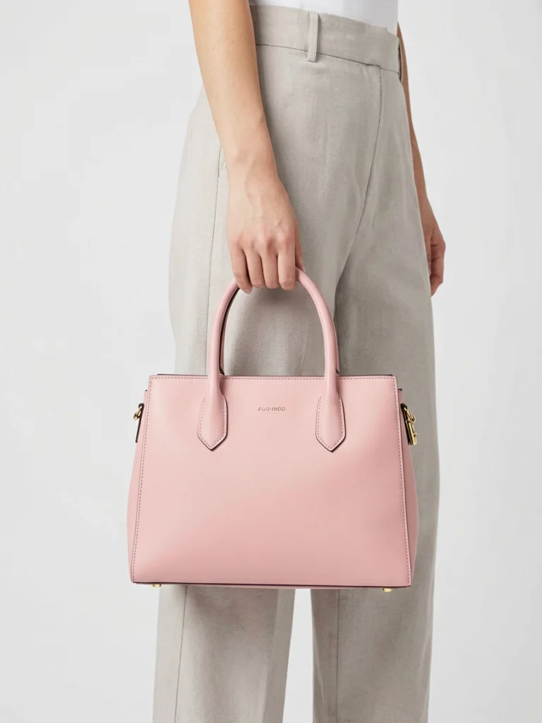 AI model holding the pink handbag